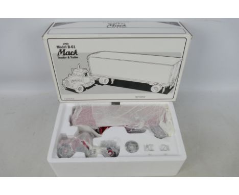 First Gear - A boxed First Gear 1:34 scale 1960 Model B-61 Mack Tractor &amp; Trailer diecast model truck. The truck appears 