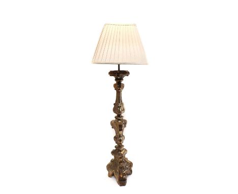 A baroque style giltwood table lamp, 18th Century, with a carved knopped stem on carved tripod base, 70cm highCondition repor