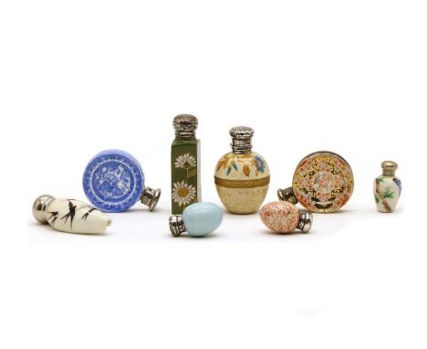 A collection of ceramic scent bottles, 19th century and later, each with silver mounts, comprising an example enamelled with 