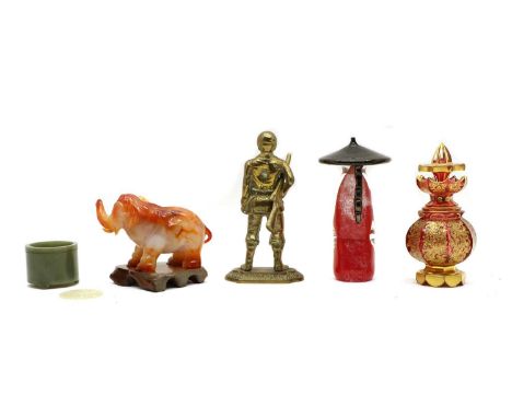 A hardstone elephant, 20th century, 10cm high, a glass figure of a chinaman, 20th century, 18cm high, a carved jade disc, 20t