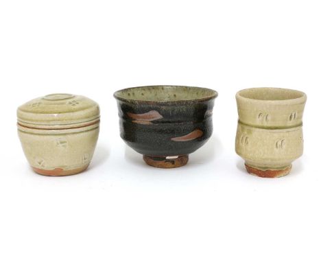 Three stoneware items, Jim Malone (b.1946), comprising, two yunomi and a lidded jar, one yunomi with a tenmoku glaze, with br