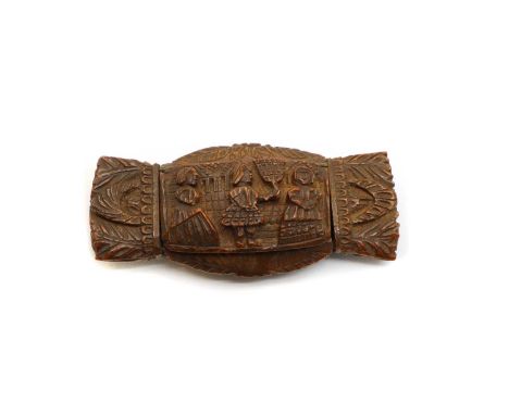 A carved snuff box, 19th century, possibly coquilla nut, decorated with figural scenes, 8.5cm wide, 3.8cm highCondition repor