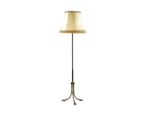 A brass standard lamp, the plain column with a spiralled geometric design, 156cm to fittingCondition report: Shade with surfa