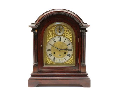 An Edwardian mahogany eight-day bracket clock, the arched brass dial with silver chapter ring and subsiduary chime/silent dia