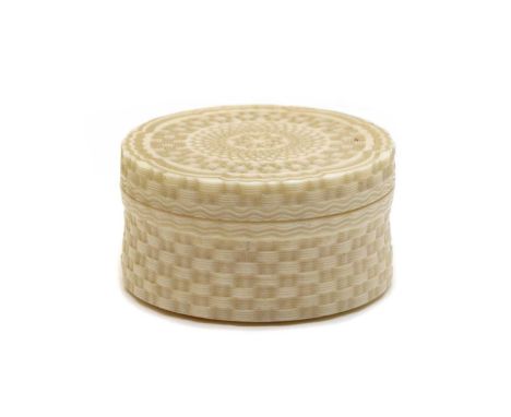 A carved cylindrical ivory box and hinged cover, 19th century, with all-over engine turned decoration and a yellow metal hing