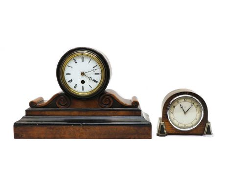 An Art Deco oak mantel clock, of arched form, to the front raised on trapezoidal bakelite feet, gilt chapter ring with Arabic