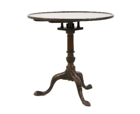 A mahogany tripod table, George III and later, the snap top with a beaded border over a bird cage, a fluted and carved column