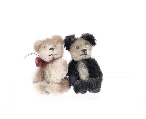 Two post-war Schuco miniature teddy bears, a panda with black and white mohair and a light brown mohair bear, both with metal