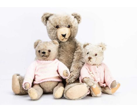 Three post-war Hermann teddy bears, the largest with light brown mohair, orange and black glass eyes, black stitched nose, mo