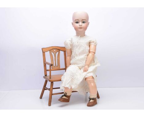 A Simon & Halbig 1079 DEP child doll, with blue sleeping eyes, pierced ears, eight ball jointed composition body, white smock