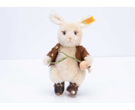 A Steiff yellow tag Benjamin Bunny, holding a radish --8in. (20cm.) high