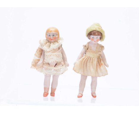 Two Hertwig all-bisque dolls' house dolls with bobbed hair, one with brown painted and moulded, the other with blonde, fixed 