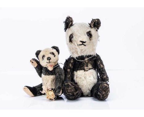 A Steiff 1950s Panda bear, with black and white mohair, orange and black glass eyes, black stitched nose, open mouth, felt fe