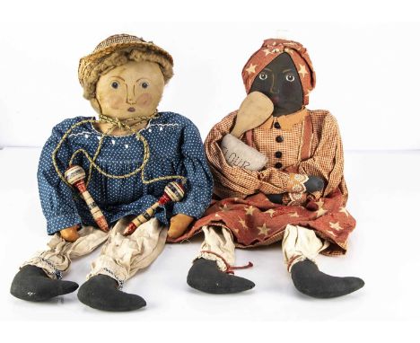 A pair of American vintage primitive cloth dolls,  a white girl with painted features, blonde wig, stuffed body with dangling