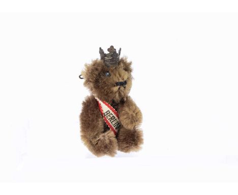 A post-war Schuco miniature teddy bear lapel pins, with brown mohair, metal pin eyes, black stitched nose, mouth and metal fr