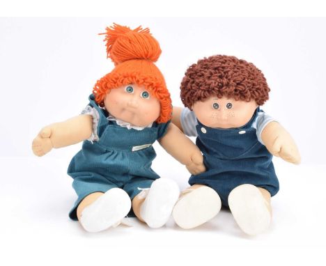 Two Cabbage Patch dolls circa 1984,  probably Jennifer Sarah and Bertram Denney, each with am adoption certificate and envelo