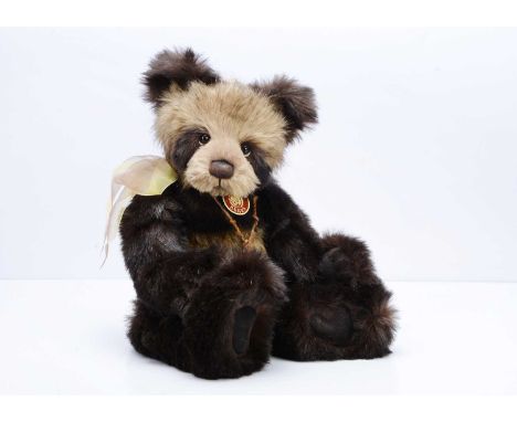 A Charlie Bears Caleb panda bear, designed by Isabelle Lee, with dark and light brown plush  and card tag --19in. (48cm.) hig