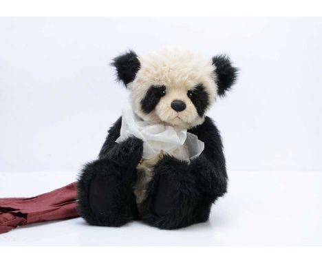 A Charlie Bears Lucas panda bear,  with  beige and black plush, card tag --17in. (43cm.) high ; and a red fabric bag