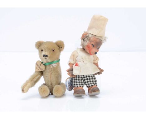 A Schuco clockwork teddy bear,  with blonde mohair, orange and black glass eyes, black stitched nose and mouth --5in. (12.5cm