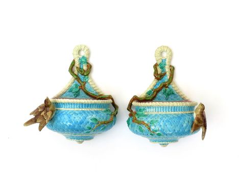 A pair of Royal Worcester Majolica wall pockets, c.1878, each modelled as a squat basket with tall back, glazed in turquoise 