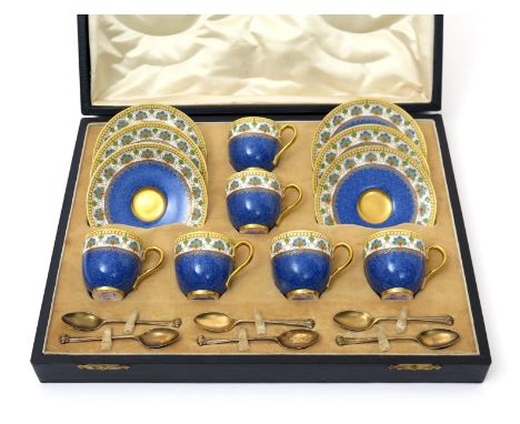 A Royal Worcester cased coffee set, date codes for 1932, decorated with a band of stylized flowers in raised enamelling above