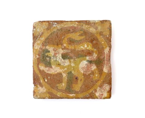 A medieval encaustic tile, 13th century, decorated in cream slip on a terracotta ground with a lion passant in a circular pan