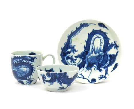 A Worcester blue and white trio, c.1760-65, comprising a teabowl, coffee cup and saucer, painted with the Dragon pattern, eac
