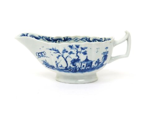 A rare Worcester blue and white sauceboat,  c.1760, of low-footed fluted form, painted with the Rearing Rock Island pattern, 