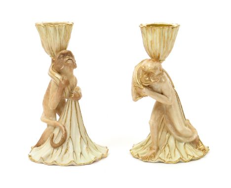 A rare near pair of Royal Worcester candlestick snuffers, c.1887, each modelled as a monkey carrying a lotus pod, a smaller p