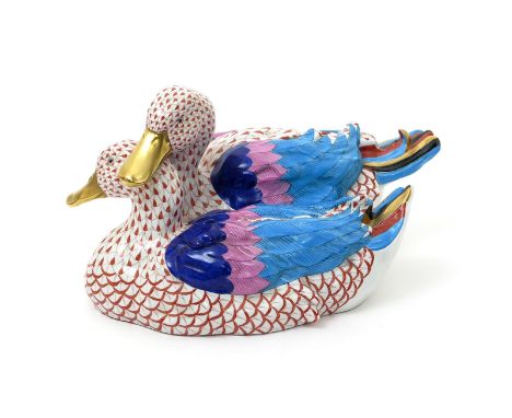 A large Herend porcelain model of two ducks, 20th century, brightly enamelled with colourful plumage and gilded beaks, nestle