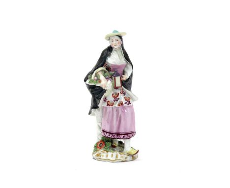 A Chelsea Gold Anchor figure of the Nightwatchman's Companion, c.1760, wearing a black cloak and holding a lantern in her lef