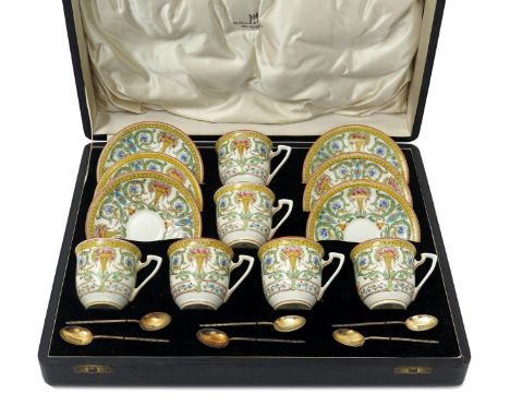 A cased Royal Worcester coffee set, date code for 1938, printed and hand-coloured with vases of roses amid foliate scrolls, t