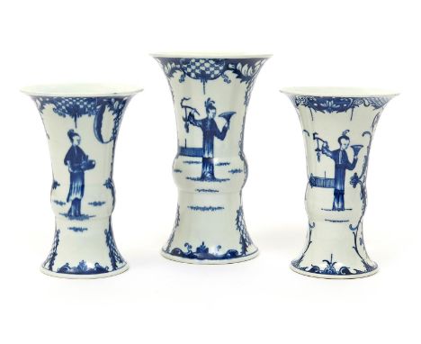 A Worcester blue and white three vase garniture, c.1770, comprising one large and two smaller vases of gu beaker form, each p