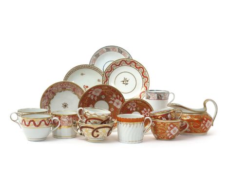 A group of English porcelain teawares, early 19th century, variously decorated in a palette of orange, gilt and black, includ