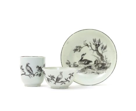 A Worcester trio, c.1760, a coffee cup, teabowl and saucer printed in black with ornithological scenes, the cup and teabowl w
