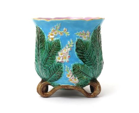 A George Jones Majolica jardinière, c.1880, the rounded form moulded with sprays of blossom issuing from behind large chestnu