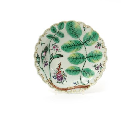 A Worcester Blind Earl plate, c.1770, moulded and painted with a rosebud and leaves, painted inbetween with small sprays of f