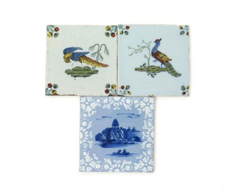 Three delftware tiles, c.1760, two painted in polychrome enamels with long-tailed birds strutting beside trees, one a Bristol