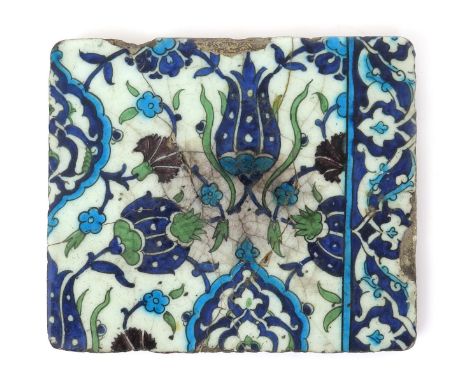 A Damascus pottery tile, c1570-90, painted in the Iznik manner with stylized flowers and seedheads in blue, green, turquoise 