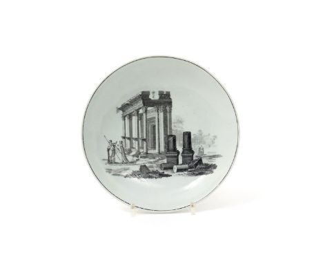 A Worcester saucer dish, c.1768, printed in black with figures standing beside Classical ruins in Palmyra, Syria, 18.7cm. The