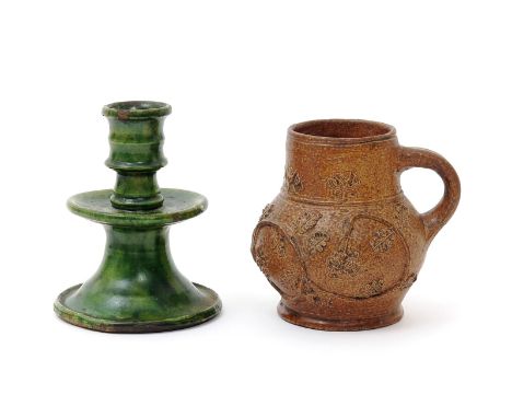 A German salt-glazed stoneware mug, 16th century, the thistle-shaped body applied with trailing oak branches, and an early Du