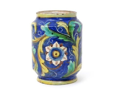 A Sicilian maiolica albarello, 18th century, the wide cylindrical body painted with six-petalled flowerheads amidst scrolling