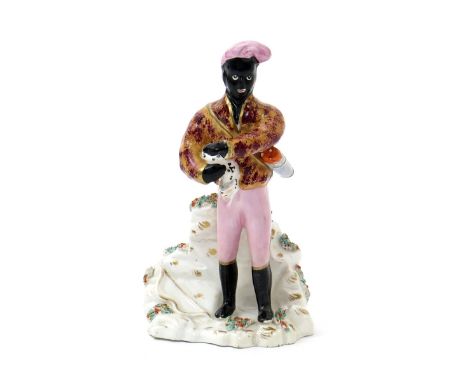 A rare Staffordshire porcelain figure of Man Friday, mid 19th century, carrying a young goat under his right arm, a quiver of