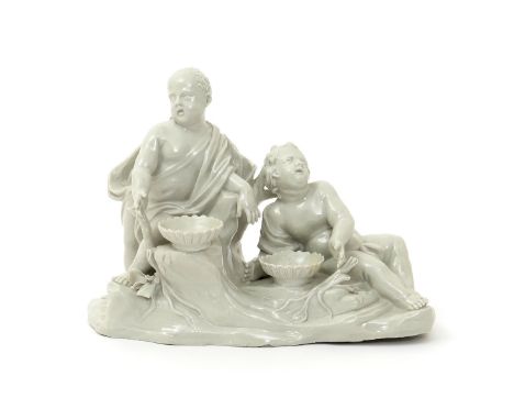 An Italian white-glazed spill vase figure group, 2nd half 18th century, probably Doccia, of two putti reclining on a rocky ba