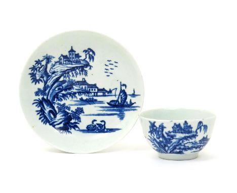 A rare Worcester blue and white teabowl and saucer, c.1757-60, printed with the Two Swan Precipice pattern, two swans swimmin