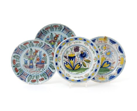 A pair of delftware plates, early 18th century, probably London, each painted in polychrome enamels with a vase and a censer 