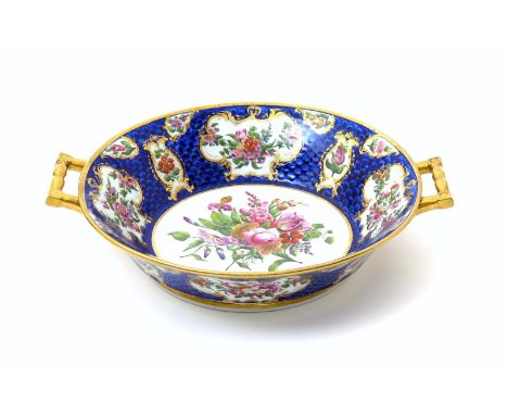 A rare Coalport centrepiece, c.1802, of circular two-handled form, painted by William Billingsley with a central floral panel
