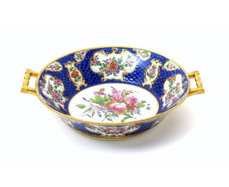 A rare Coalport centrepiece, c.1802, of circular two-handled form, painted by William Billingsley with a central floral panel