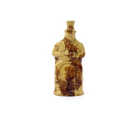 A Rockingham pottery figural spirit flask, dated 1830, modelled as a man in a top hat, seated astride a barrel and holding a 