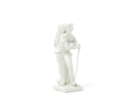 A Bow white-glazed figure of a travelling pedlar, c.1754, standing with a large bag on his back, leaning on a tall stick, rai